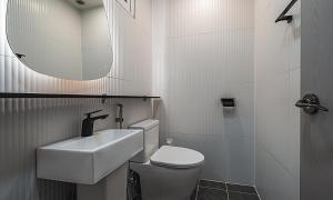 a bathroom with a sink and a toilet and a mirror at Chuncheon Bali 376 in Chuncheon +43 photos