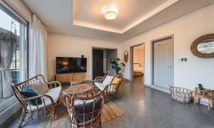 a living room with a table and chairs and a television at Chuncheon Bali 376 in Chuncheon