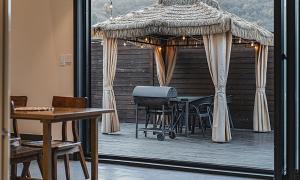 a table and chairs on a deck with a umbrella at Chuncheon Bali 376 in Chuncheon