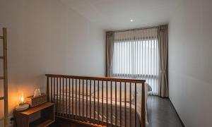 a bedroom with a crib and a window with a bed at Chuncheon Bali 376 in Chuncheon