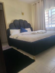 Кровать или кровати в номере GG PREMIUM Ngala 3br Five Beds