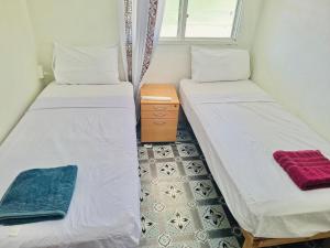 Ένα ή περισσότερα κρεβάτια σε δωμάτιο στο Tonga Horizon Cottage - Entire Place