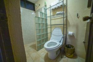 a bathroom with a white toilet in a room at Large family house in Cabo , pet friendly in Cabo San Lucas +19 photos
