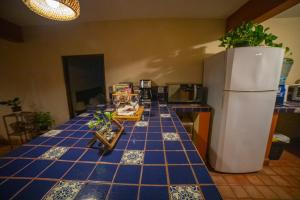 a kitchen with a blue tiled counter top with a refrigerator at Large family house in Cabo , pet friendly in Cabo San Lucas
