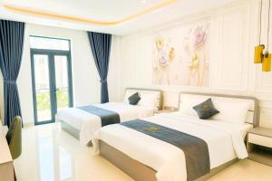 two beds in a white room with blue curtains at 6668 Hotel - Chi nhánh 2 in Tây Ninh +12 photos