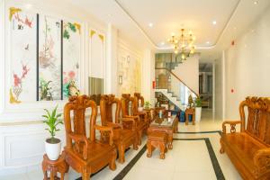 a dining room with wooden chairs and a chandelier at 6668 Hotel - Chi nhánh 2 in Tây Ninh