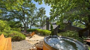 a backyard with a hot tub and a wooden table at Sonoma Skyhouse by AvantStay Pool Sauna Hot Tub Stunning Valley Views in Sonoma