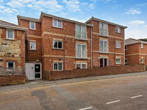 a brick building on the side of a street at 2 Bed in Freshwater oc-94561 in Freshwater