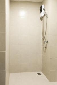 a shower with a shower head in a bathroom at MUXA&Vay in Pattaya North