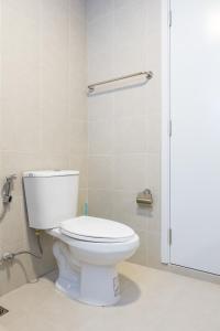 a bathroom with a toilet and a shower at MUXA&Vay in Pattaya North