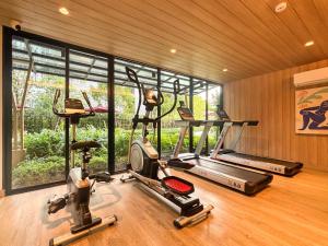 a gym with three exercise machines and a large window at MUXA&Vay in Pattaya North +15 photos