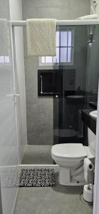 une salle de bain avec une douche avec des toilettes et un lavabo dans l'établissement Pousada Coisa Nossa - Praia Cibratel II - 200m da praia, à Itanhaém