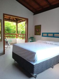 Ένα ή περισσότερα κρεβάτια σε δωμάτιο στο Casa Arraial Ajuda Jardim da Mata