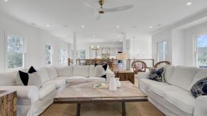 a living room with white couches and a coffee table at 6 36th Avenue by AvantStay Stunning Private Pool in Isle of Palms