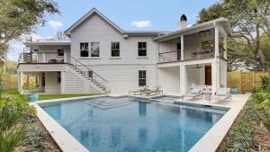 a house with a swimming pool in front of a house at 6 36th Avenue by AvantStay Stunning Private Pool in Isle of Palms