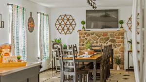 a dining room with a table and chairs and a fireplace at Mountain Mindset by AvantStay Pool Hot Tub Game Room Firepit in Long Pond