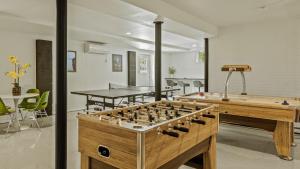 a living room with a table and a chessboard at Mountain Mindset by AvantStay Pool Hot Tub Game Room Firepit in Long Pond