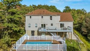 an aerial view of a house with a swimming pool at Mountain Mindset by AvantStay Pool Hot Tub Game Room Firepit in Long Pond