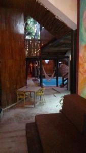 a room with a table and a hammock in it at Las cabañas duo in Tulum