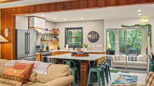 a kitchen and living room with a table and chairs at The Horseshoe Hideaway Lake Harmony Cabin w Hot Tub Game Porch in Lake Harmony