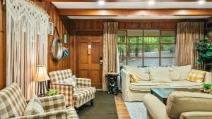 a living room with a couch and chairs and a table at The Horseshoe Hideaway Lake Harmony Cabin w Hot Tub Game Porch in Lake Harmony