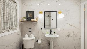 a white bathroom with a sink and a toilet at The Horseshoe Hideaway Lake Harmony Cabin w Hot Tub Game Porch in Lake Harmony +43 photos