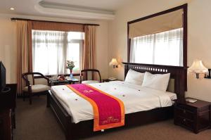 Ένα ή περισσότερα κρεβάτια σε δωμάτιο στο Camela Hotel & Resort