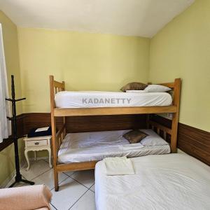 een kamer met twee stapelbedden in een kamer bij Casa Ventilada e Confortável, Perto da Rodovia e 2km da Praia in Caraguatatuba