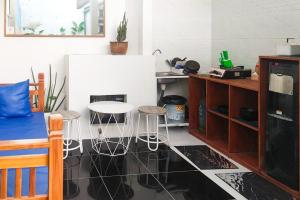 a kitchen with a table and stools in a room at The Lavana Rumah Keboon in Mataram