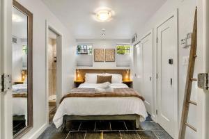 Luxe Logan Circle Escape - Near Downtown DC & Shaw في واشنطن: غرفة نوم بها سرير كبير ومرآة