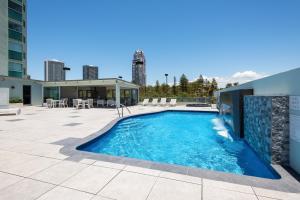 a swimming pool on a patio next to a building at The Waterford on Main Beach in Gold Coast