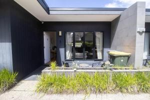 a black house with a table and some plants at Lakes Edge 4 in Wendouree