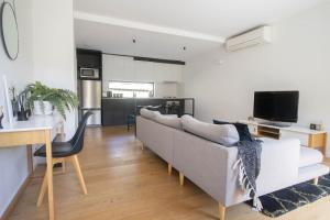 a living room with a couch and a table at Lakes Edge 4 in Wendouree +5 photos