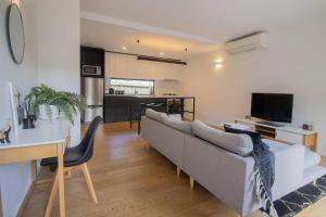 a living room with a couch and a kitchen at Lakes Edge 4 in Wendouree