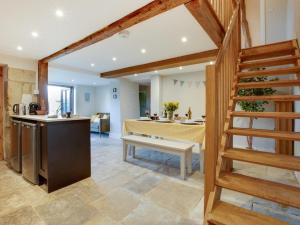 a kitchen and a living room with a table and a staircase at 3 Bed in Ventnor oc-93697 in Niton