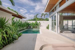 an indoor swimming pool in the backyard of a house at The Outside Design Suites in Uluwatu