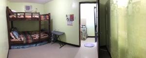 a room with two bunk beds and a hallway at ACA Transient House in Nasugbu +1 photo