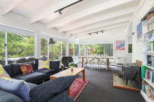 a living room with blue couches and a table at Finchley in Blackheath