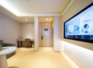 a room with a large screen on the wall at JI Hotel Hangzhou Banshan Road in Hangzhou