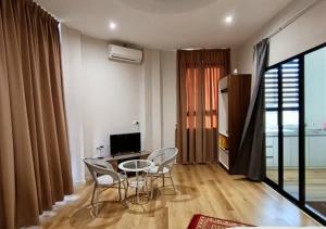 a living room with a table and chairs and a television at Homestay KNK in Tawau