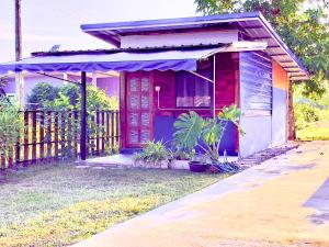 a small house with a red door and a porch at Lamai home 4 in Ko Yao Noi