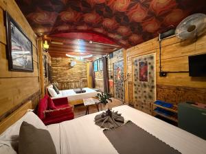 大叻Redhouse Dalat Hotel的一间设有床铺和客厅的房间 更多177张照片