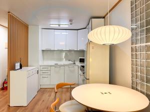 a kitchen with a table and a table and chairs at Modern 203 Stay in Seoul +20 photos