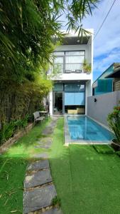 a house with a swimming pool in the yard at Tehya Villa in Da Nang
