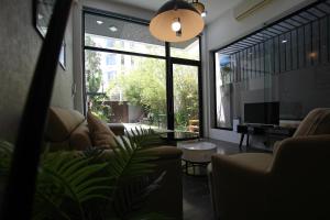 a living room with a couch and a large window at Tehya Villa in Da Nang