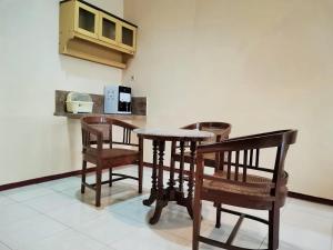 Villa Graha Permata 3 في باتو: طاولة وكراسي في مطبخ مع كونتر