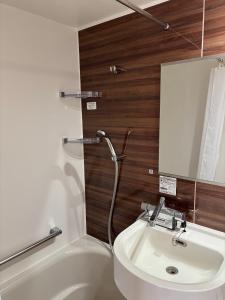 a bathroom with a sink and a toilet and a mirror at Yura terrace in Yura