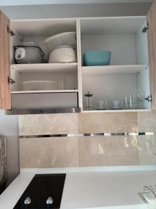 a kitchen with a cupboard filled with dishes at The new concept office plus in Ban Fon