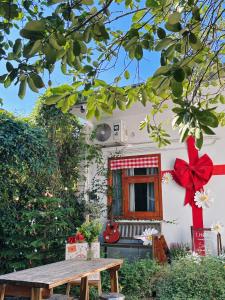 a house with a red bow and a picnic table at 1.Hôme in Hanoi +77 photos