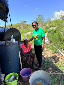 a man and a woman standing next to some bins at Superstar Living in Treasure Beach